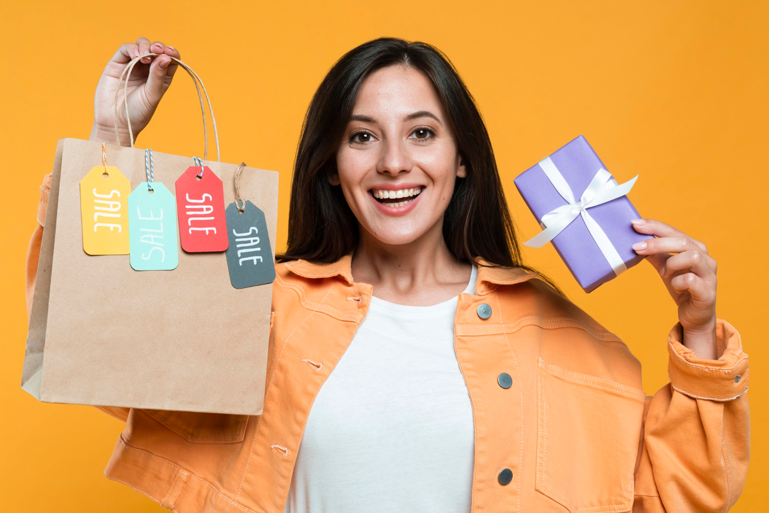 Person wearing a jacket smiling and holding a product with a "SALE SALE SALE" text, motivating Instagram clients to return for more sales.